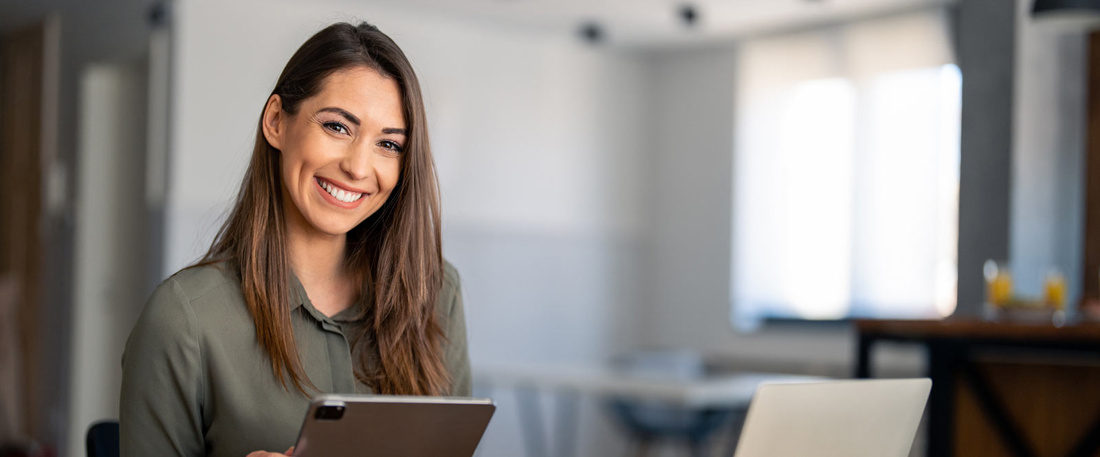 Business woman holding a tablet in an office environment. 