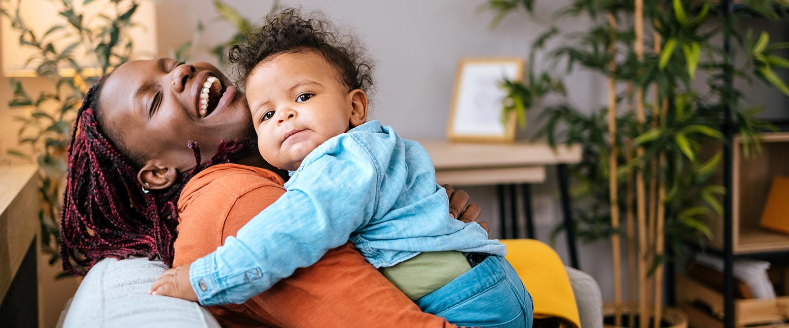 Woman and child on couch at home.