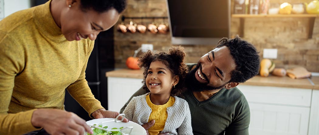 Mom, dad and child eating dinner.