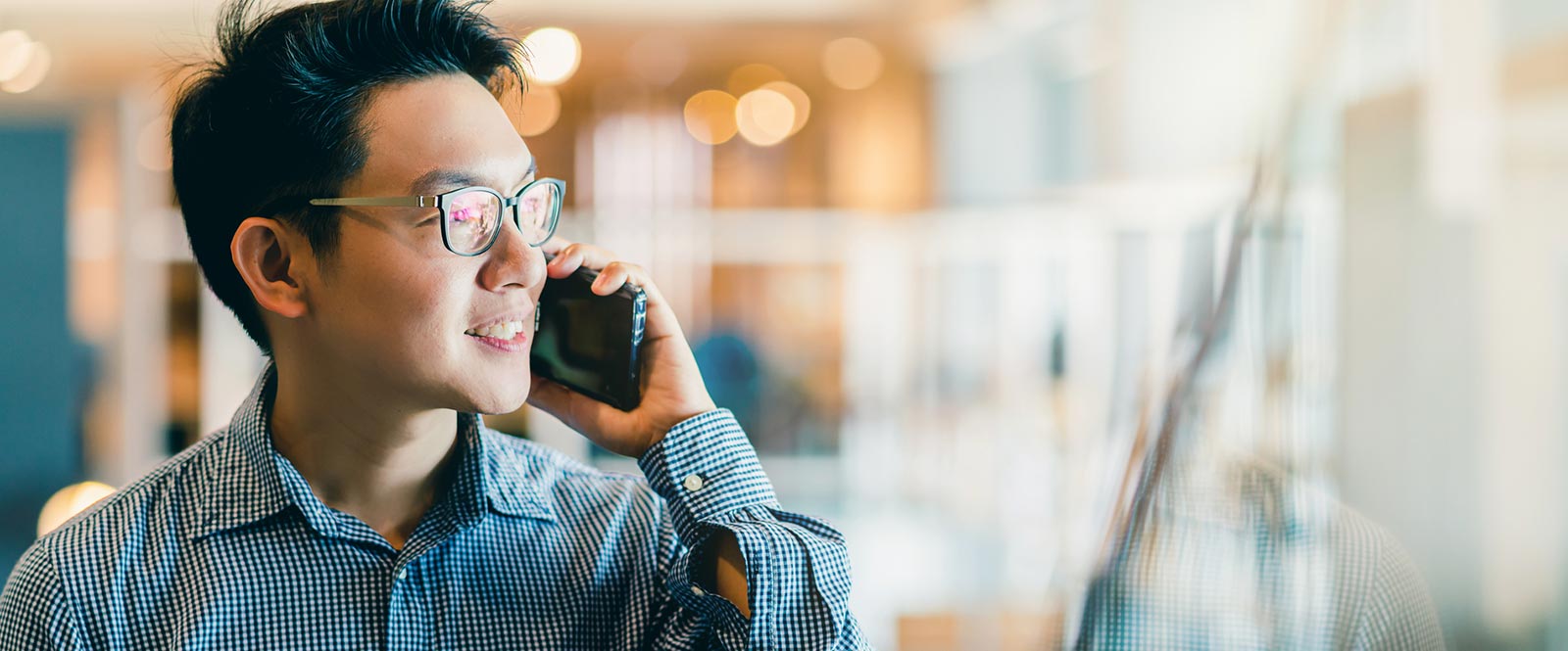 Man talking on the phone in an office.