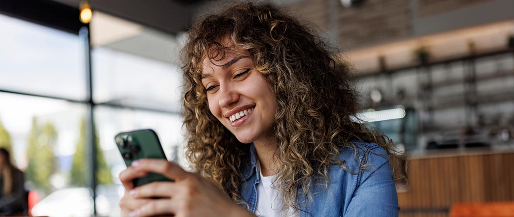 Woman using phone in restaurant. 